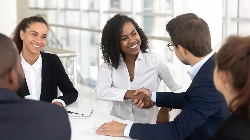 Multiracial businessman businesswoman shake hands starting collaboration at group