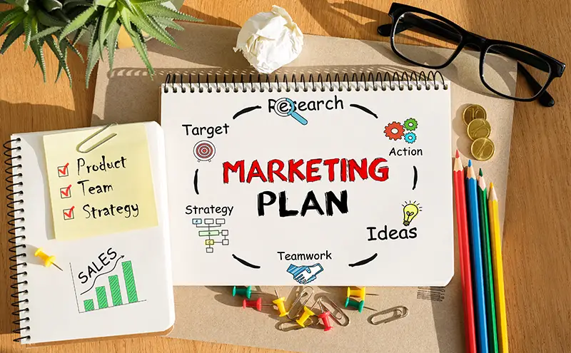Notebook with Toolls and Notes about Marketing Plan