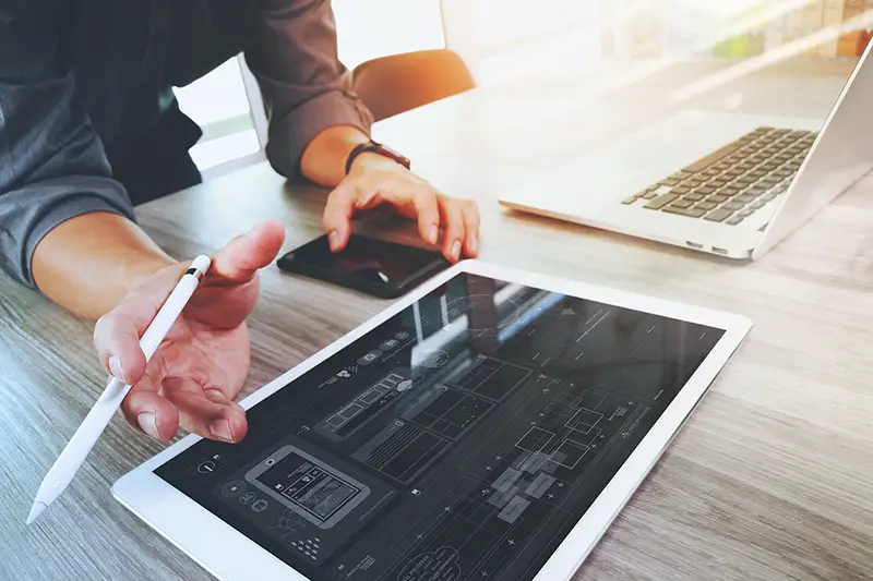 Web developer working on his digital black tablet