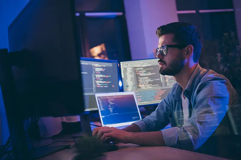 Young male working in front of his computer