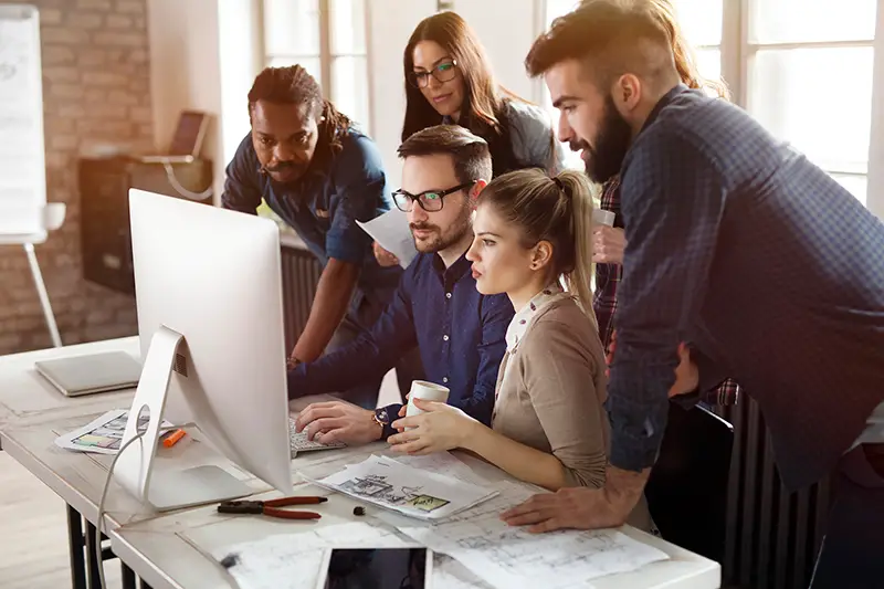 Marketing team working in front of computer