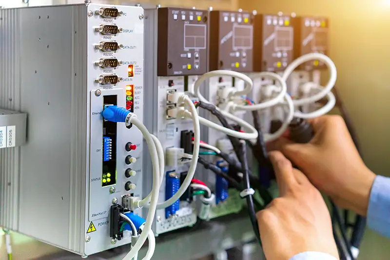 View of communication ports on servo controller in control box of automation machine