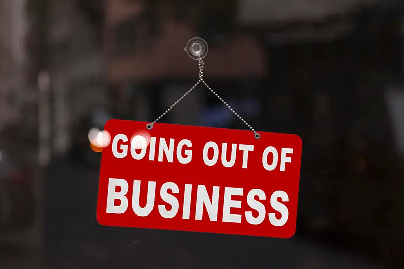 Close-up on a red closed sign in the window of a shop