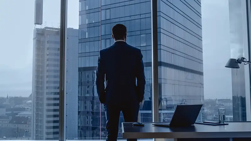 Businessman wearing a Suit Standing in His Office