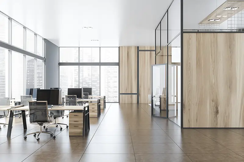 Interior of stylish open space office with gray and wooden walls