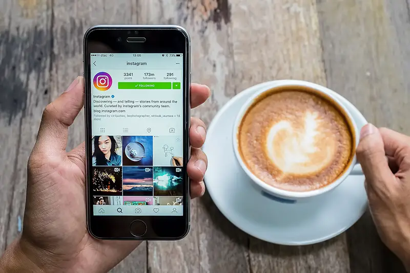 A women holds Apple iPhone 6S with Instagram application on the screen