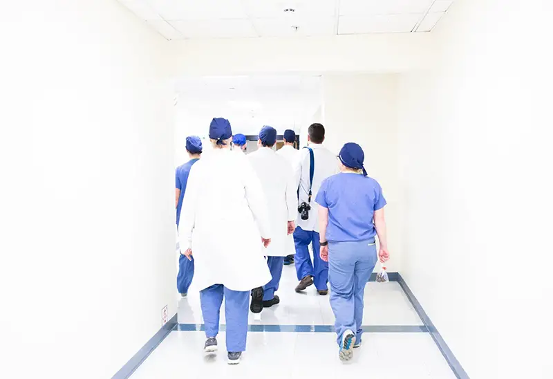 Healthcare workers walking in the hospital hall