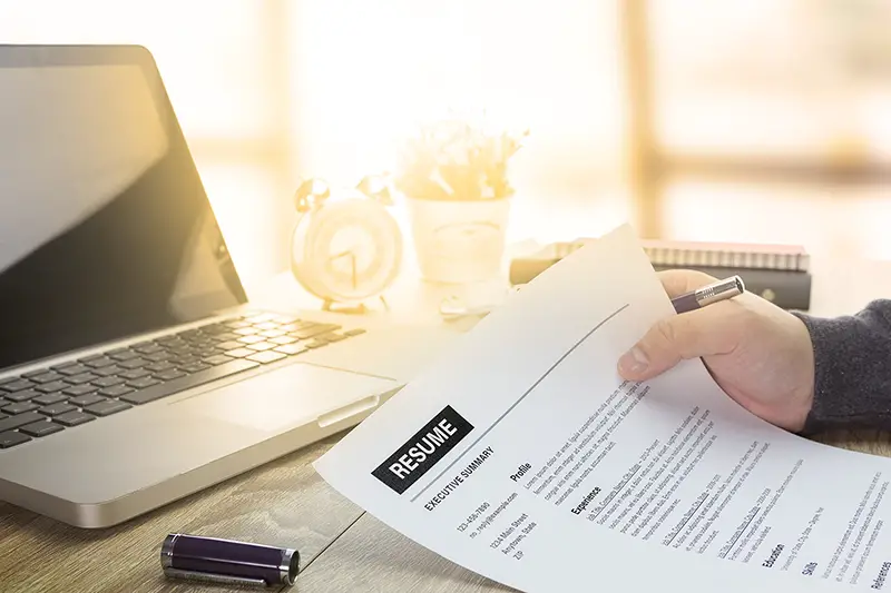 job seeker review his resume on his desk