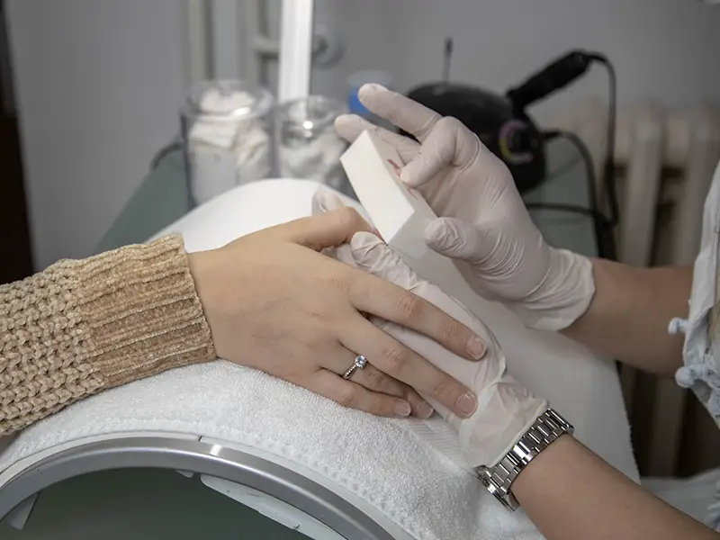 Nail technician working on a client