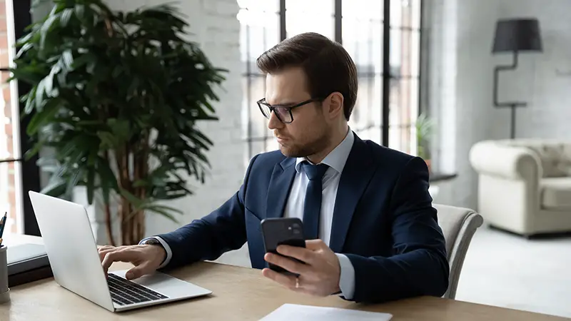 employee sit at desk in office work online on laptop