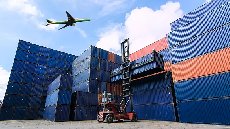 Forklift handling container box loading to freight trainer