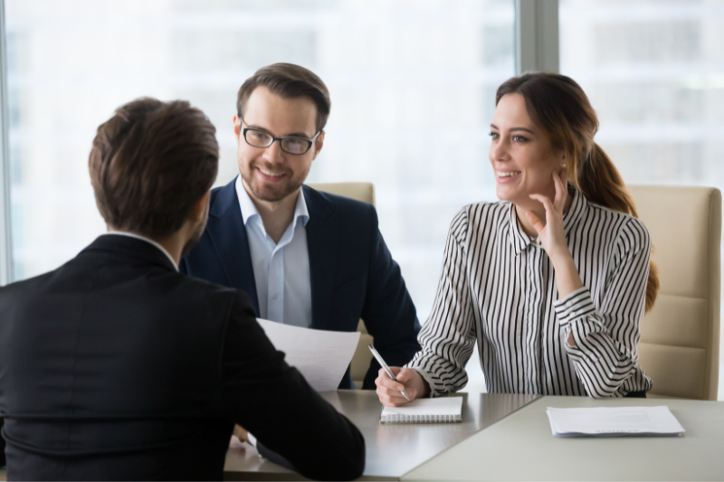 Male and female recruiter interviewing a male applicant
