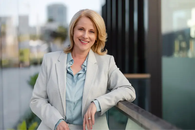 CEO older business woman standing outside workplace