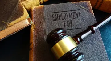 Employment law book with legal gavel