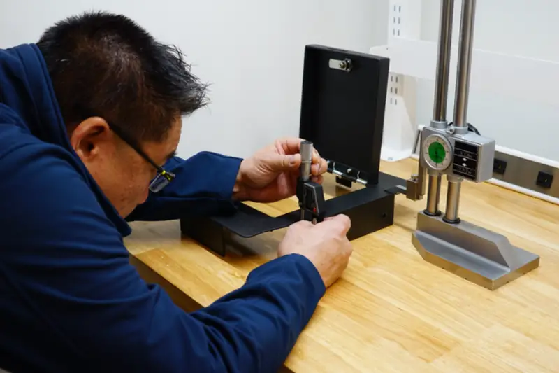 Male engineer using a micrometer