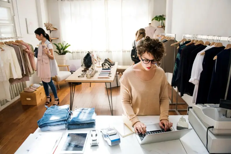 A female business owner is using the laptop