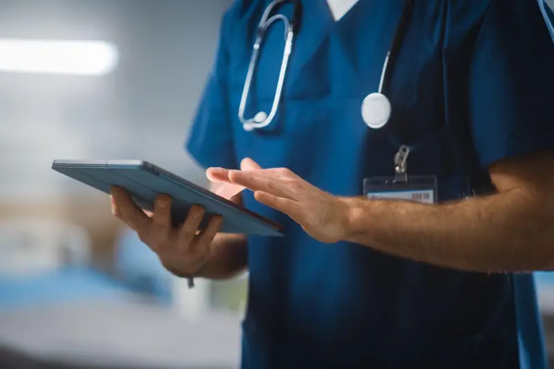 Male doctor using tablet android