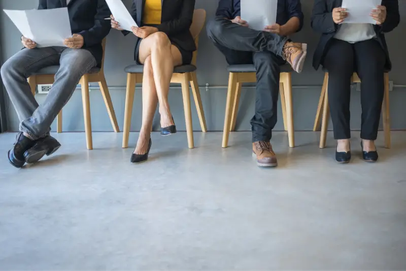 Group of people sitting waiting for a job interview