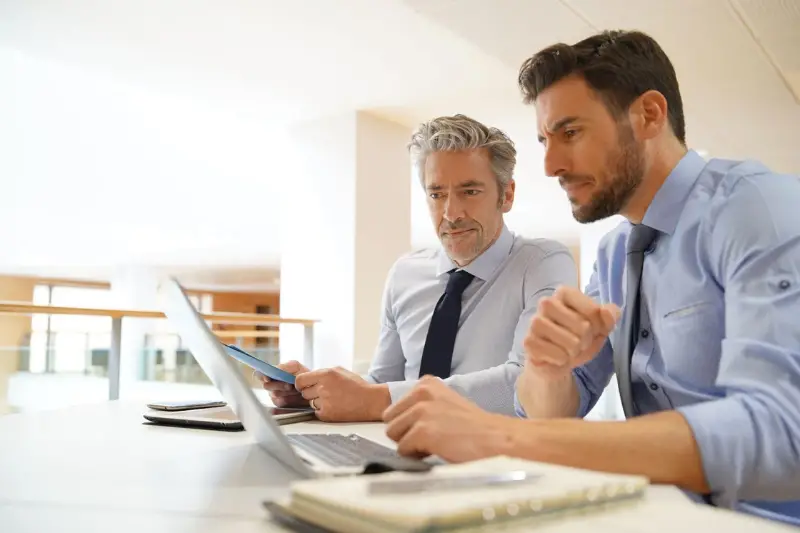 Businessmen working in front of their laptop