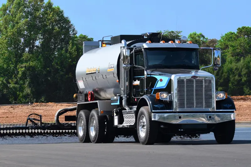 Gray vacuum truck on the road