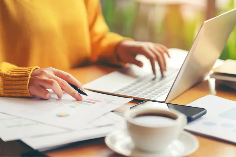 Woman processing and checking financial report