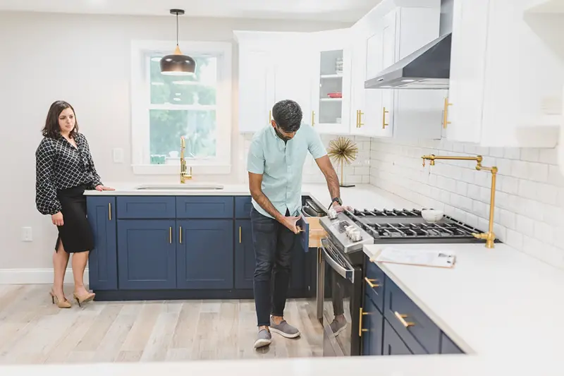 A man inspecting the kitchen drawer