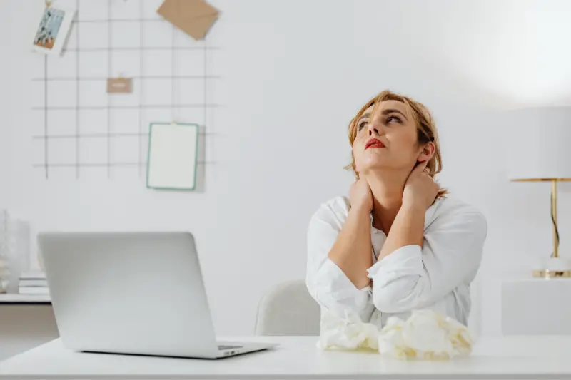 Woman working from home experiencing a back pain