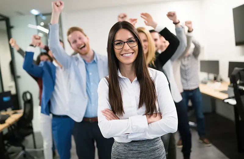 Happy business people celebrating success at company