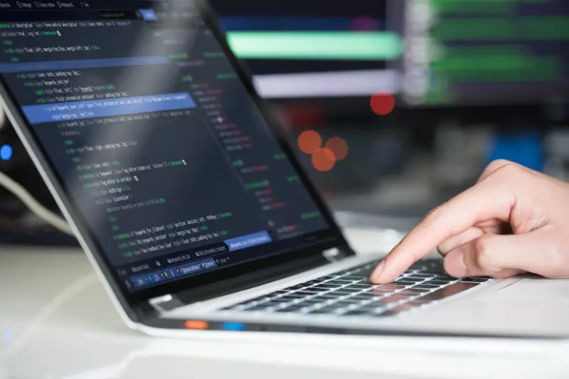 Person typing on silver laptop keyboard