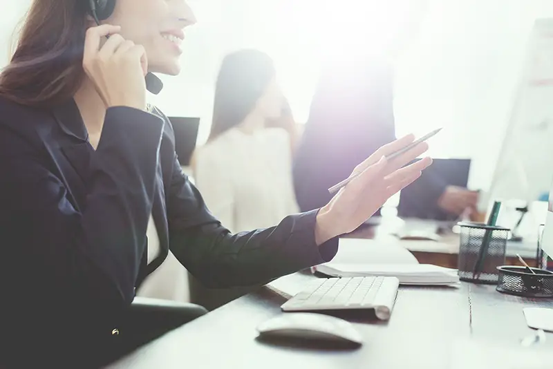 Young woman talking on the phone working as customer service provider