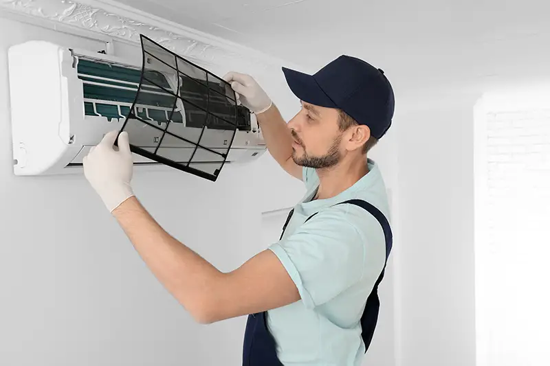 Man cleaning the aircondition filter
