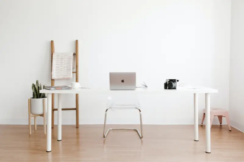 Silver macbook on white table