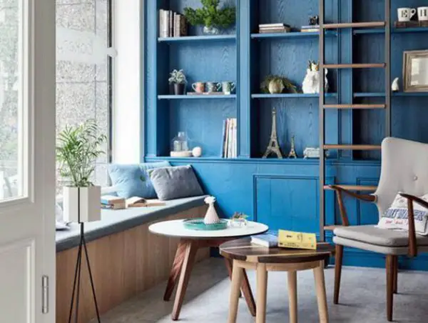 Small room with blue painted built in cabinet on the wall