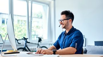 Cheerful consultant working at home