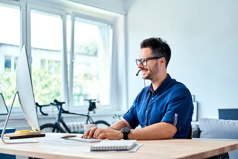 Cheerful consultant working at home