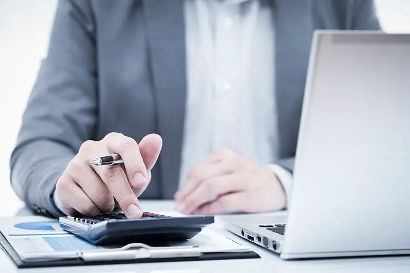 Businessman analyzing investment charts with laptop