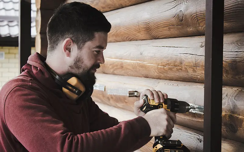 Worker drilling the wall