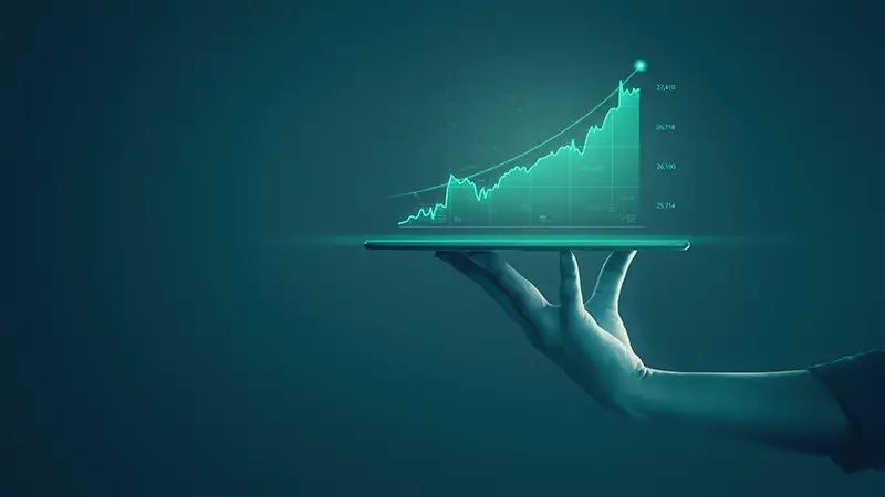 Business man holding tablet and showing holographic graphs and stock market statistics gain profits.