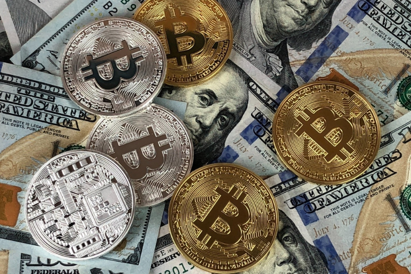 Bitcoins and paper dollar bills