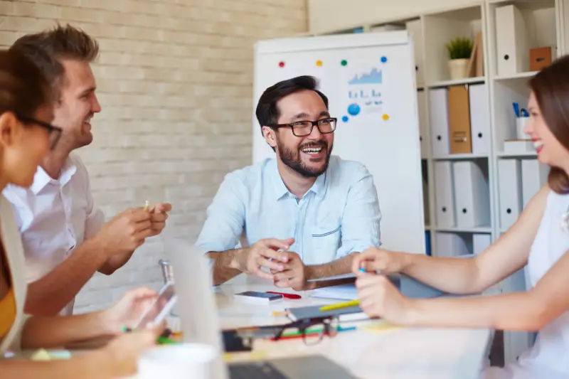 Male boss having a healthy discussion with his employees