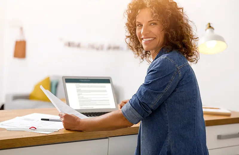 Middle age woman at the office working with a laptop