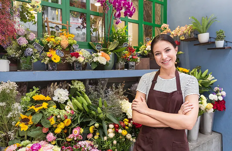  small business entrepreneur owne standing with flowers at florist shop