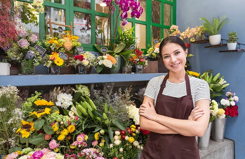 small business entrepreneur owne standing with flowers at florist shop