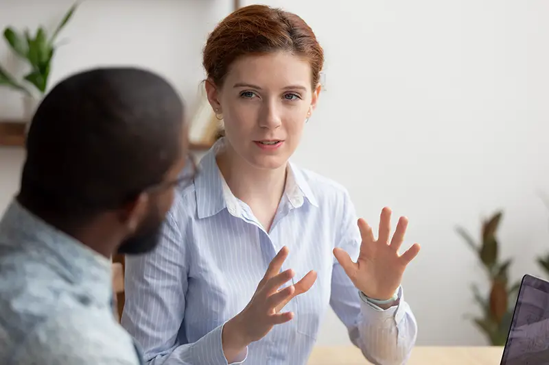 Man and woman colleagues talking in their work