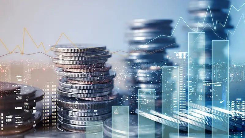 Double exposure of graph and rows of coins for finance and business concept