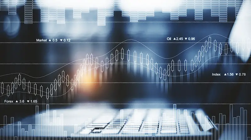 Side view and close up of laptop placed on desktop with abstract forex chart.