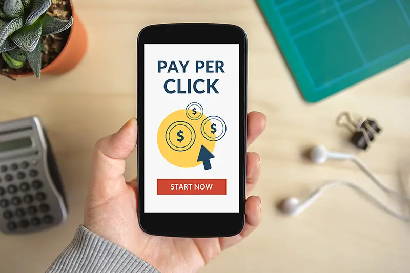 Hand holding smart phone with Pay Per Click (PPC) concept