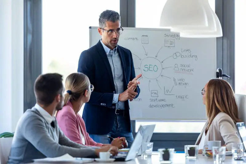 Businessman explaining a project to his colleagues on coworking place