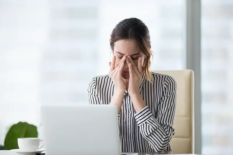 Tired businesswoman massaging eyes feeling strain fatigue