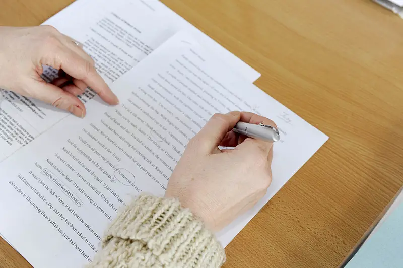 Hand woman writing on a white paper